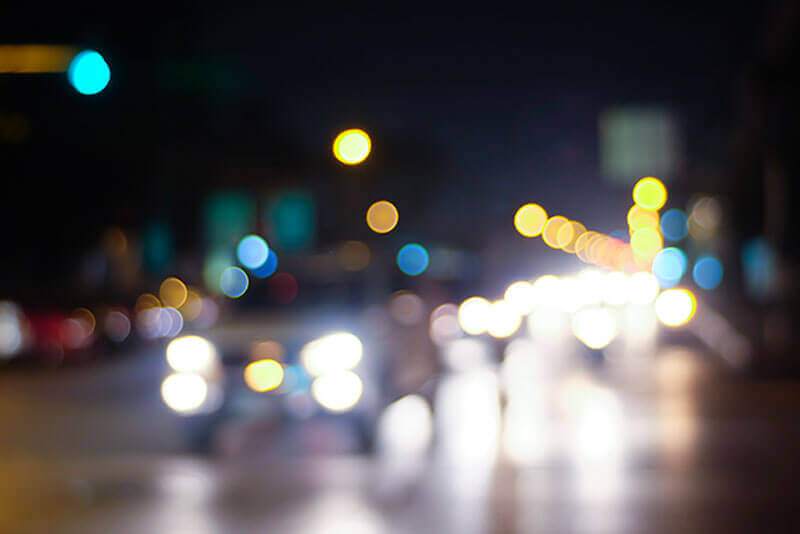Blurry Image of Cars on a Road at Night